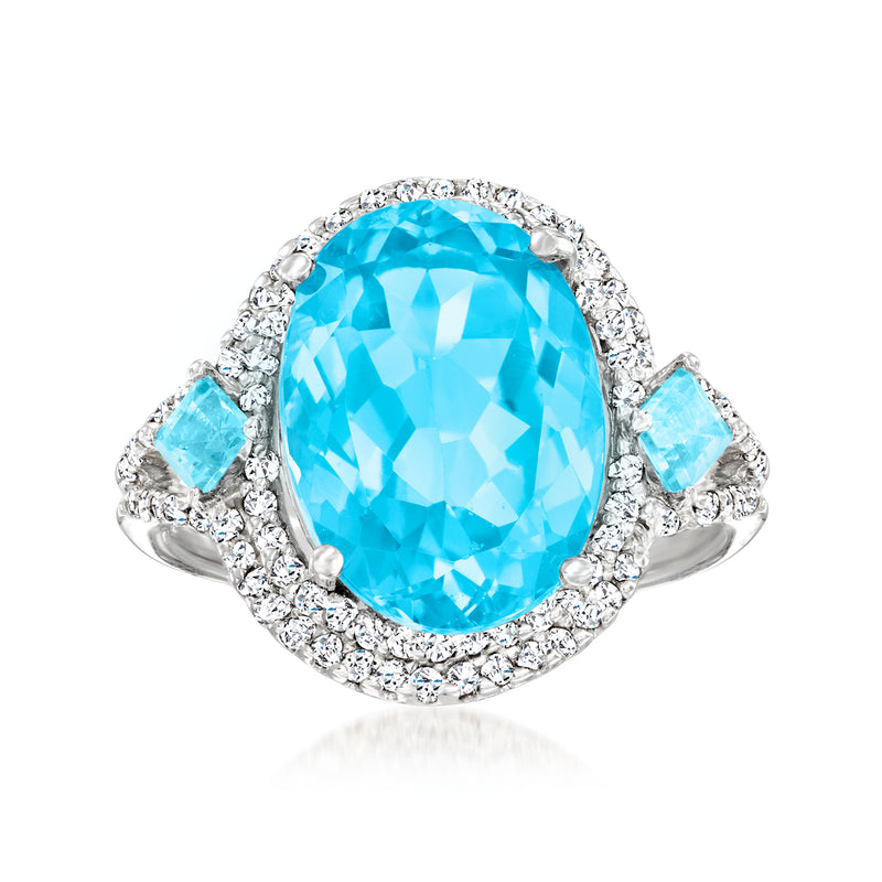 14kt white gold ring with oval sky blue topaz center and diamond halo, side stones