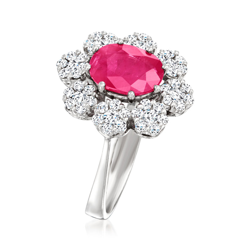 White gold ring with oval pink ruby centerpiece framed by round diamond clusters
