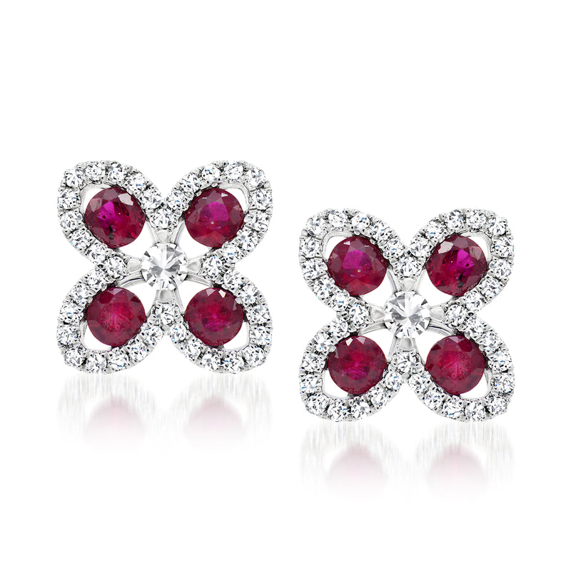 Ruby and diamond flower post earrings in 14kt white gold with red round stones