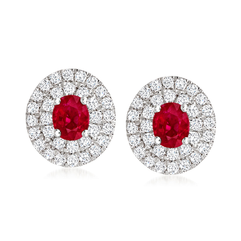 Ruby and diamond stud earrings with red oval center and diamond halo in white gold