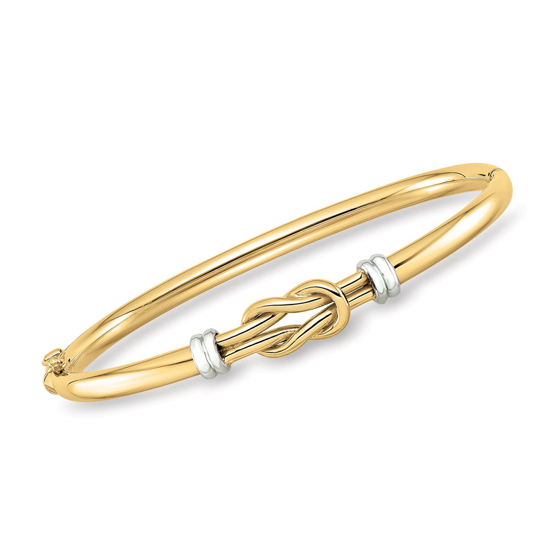 Two-tone 14kt gold love knot bangle bracelet with hinged clasp and round wire design