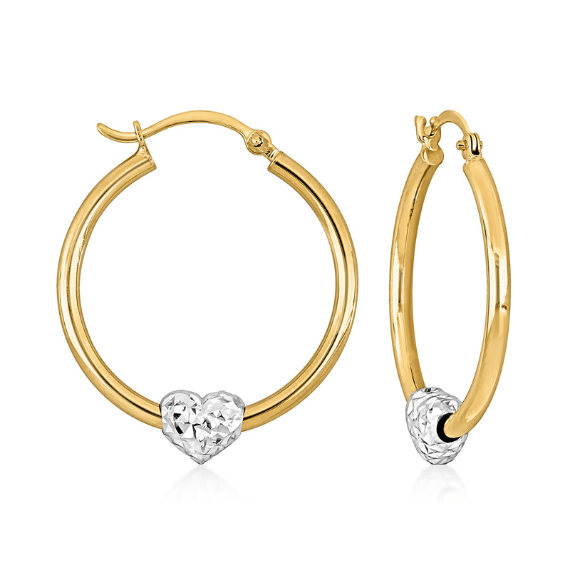 Two-tone gold heart charm hoop earrings with clear heart pendant on front hoop
