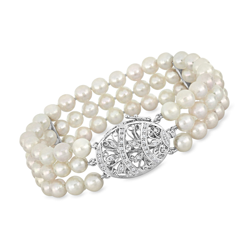 Three-row cultured pearl bracelet with oval filigree clasp and diamond accents in white metal