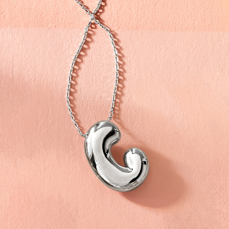 Sterling silver bubble initial pendant necklace with glossy rounded letter charm close-up