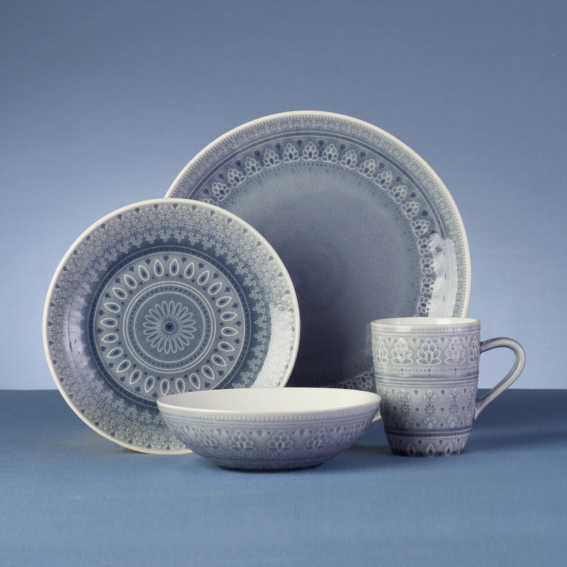 Gray stoneware dinnerware set with blue floral medallion plates, bowl, and mug