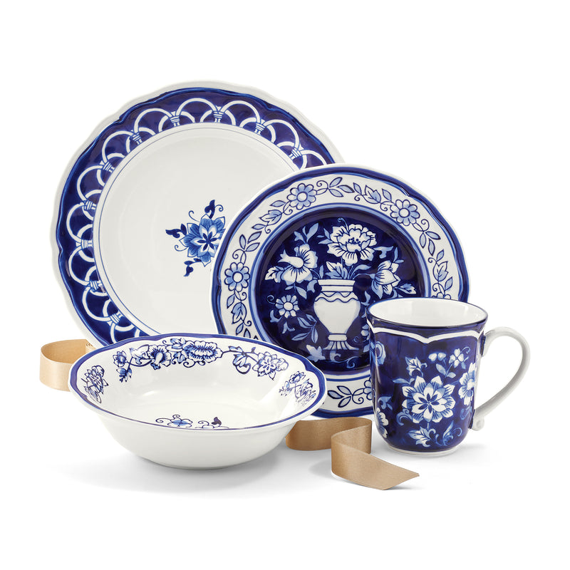 Hand-painted stoneware dinnerware set with blue floral plates, bowl, and mug