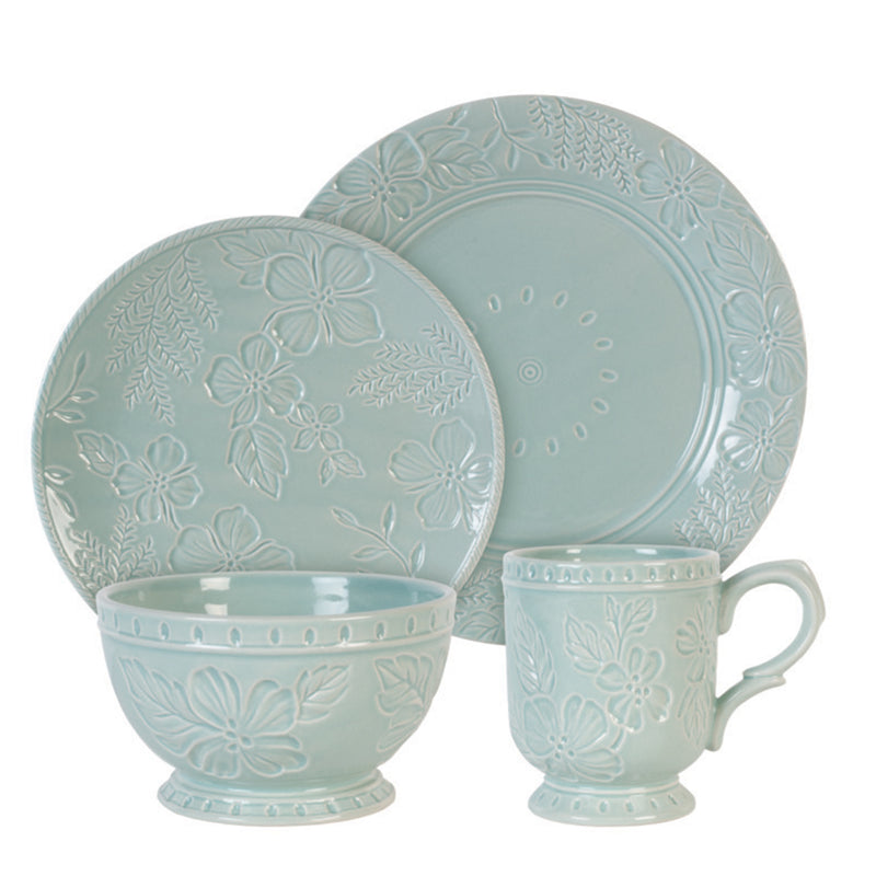 Dinnerware set in light blue with embossed floral pattern: plates, bowls, and mugs