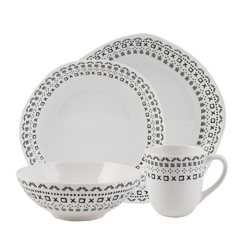 White dinnerware set with black geometric pattern: plates, bowls, and mug.