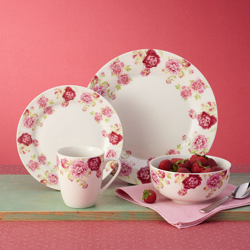 Porcelain dinnerware set with floral rose plates, mug, and bowl with strawberries