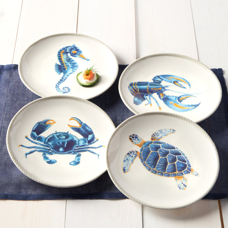Set of four ceramic bowls with blue crab, shrimp, and sea turtle designs