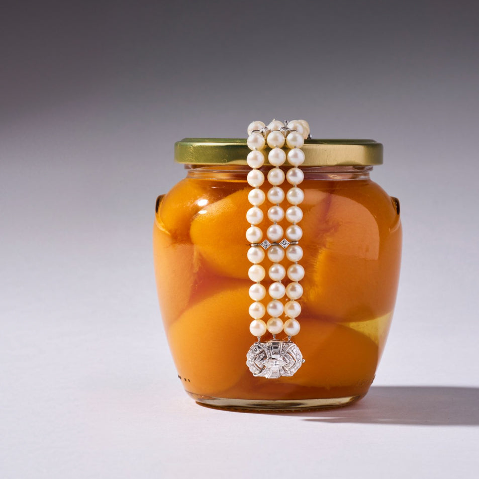 Pearl bracelet sitting over a jar