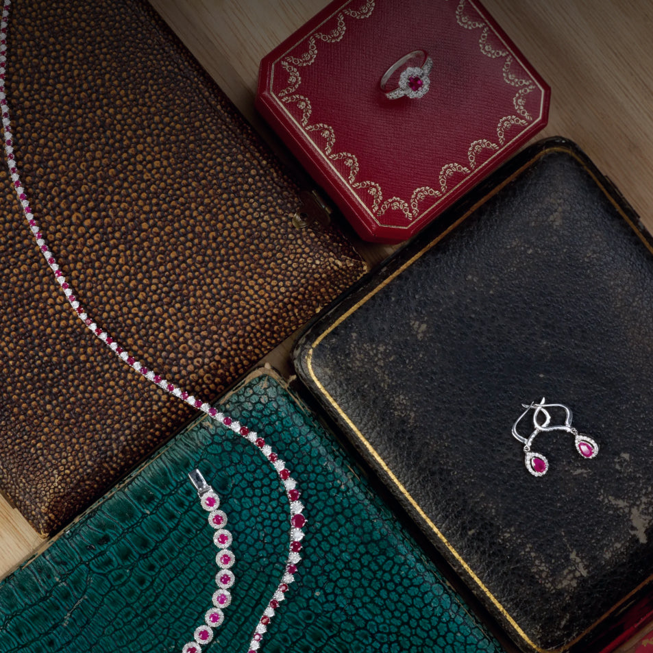 Pink Stone assorted jewelry on top of jewelry boxes in different colors