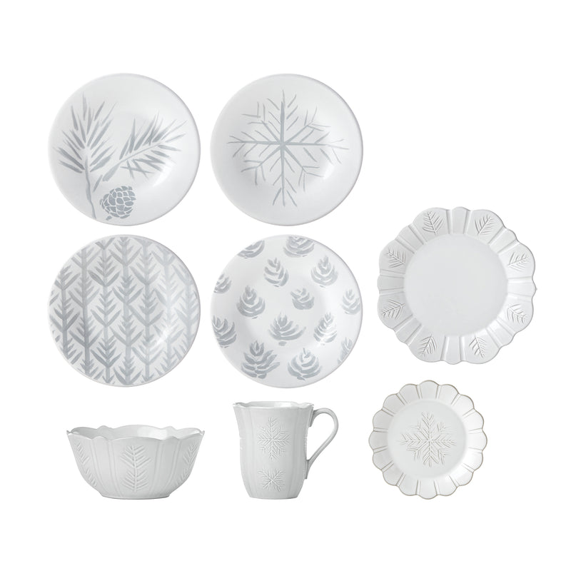 Ceramic dinnerware set with gray carved winter motifs, featuring plates, bowls, and mug