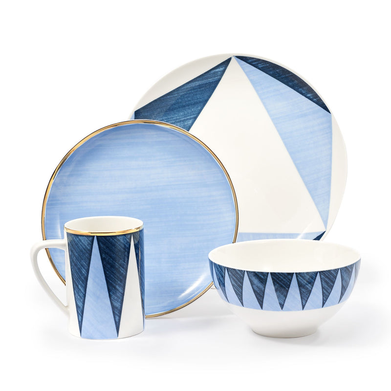 Porcelain dinnerware set: blue geometric plates, bowl, and mug on white