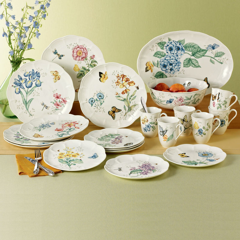 Porcelain dinnerware set with blue and pastel butterfly meadow floral pattern, plates, bowls, mugs