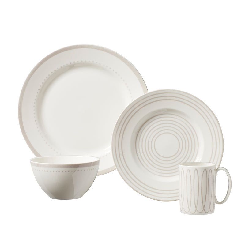 Dinnerware set with striped plates, mug, and bowls in white and light gray