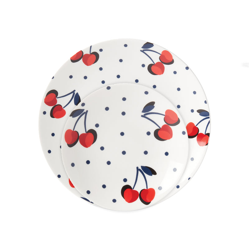 White dinner plate with blue dot pattern and red cherry motif