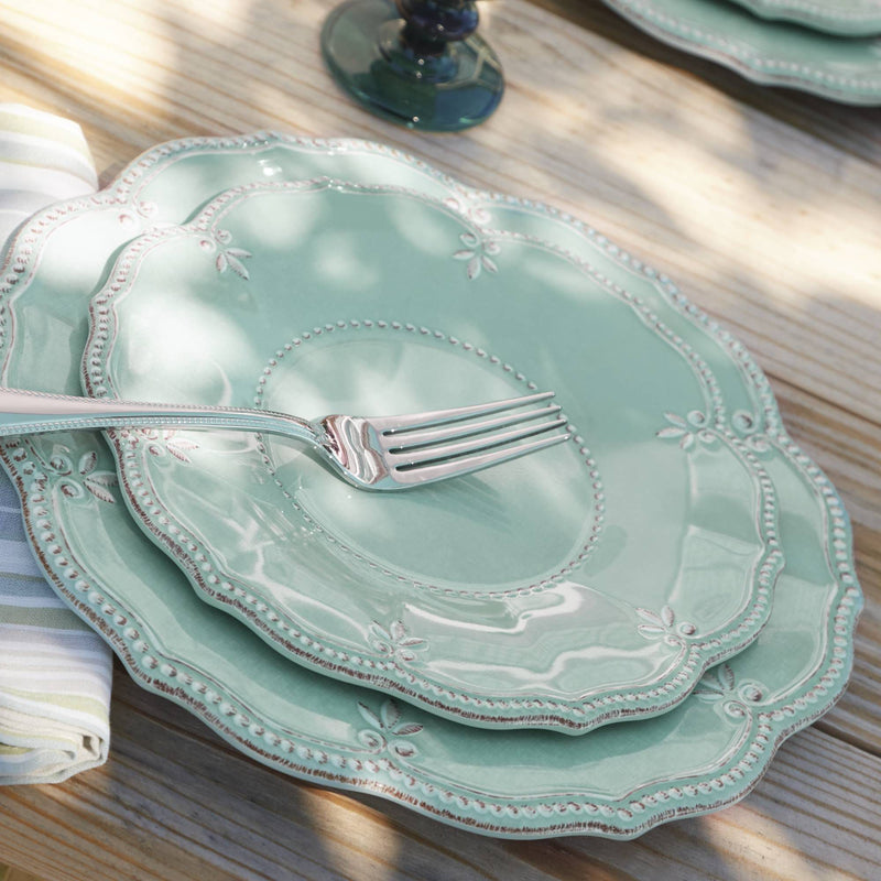 Aqua melamine dinnerware set with scalloped edge and floral rim, includes fork, plate, and bowl