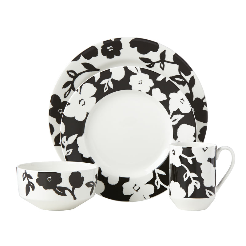 4-piece ceramic place setting with black-and-white floral plates, bowls, and mug