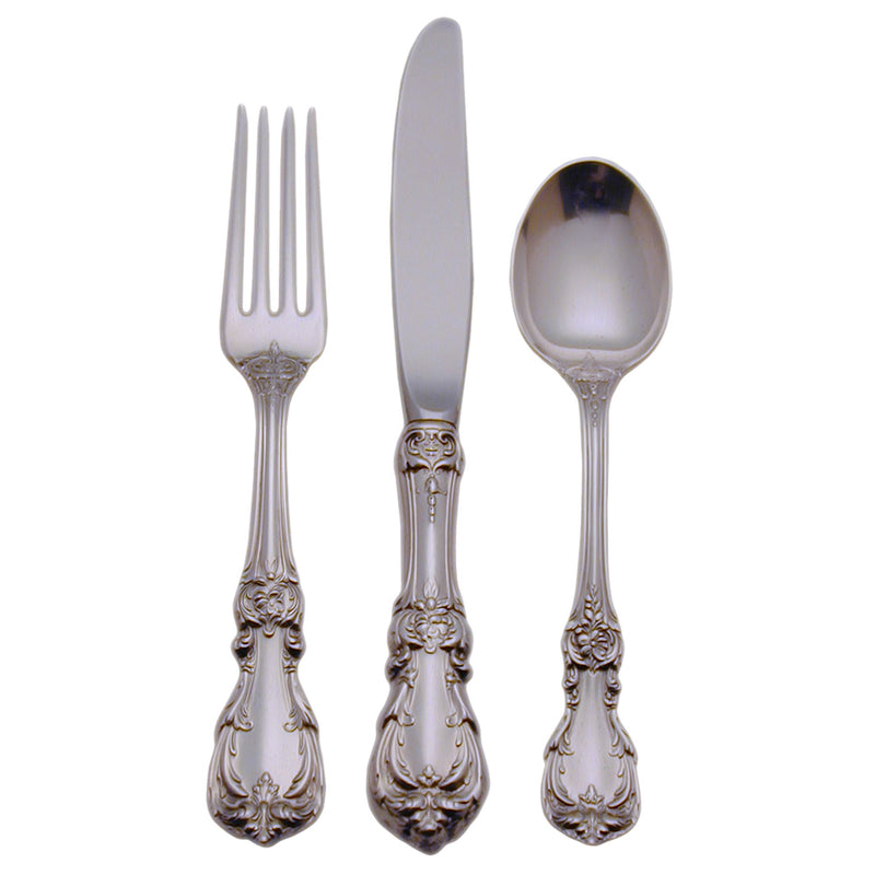 Sterling silver flatware set with ornate handles: fork, knife, and spoon