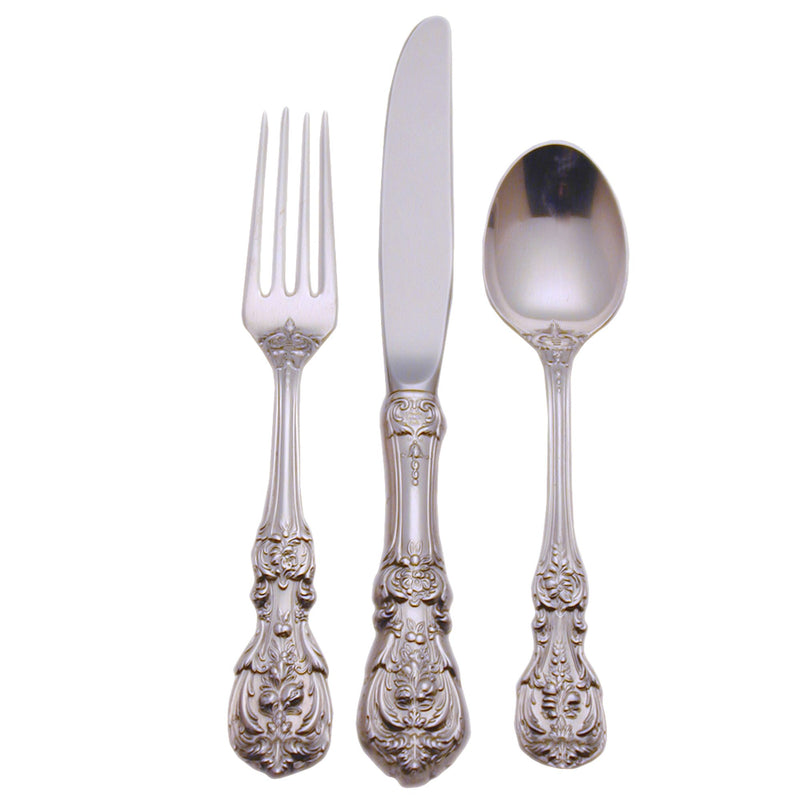 Sterling silver flatware set with ornate handles: fork, knife, and spoon