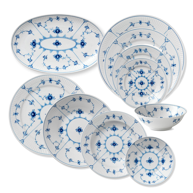 Blue fluted porcelain dinnerware set with blue floral border plates and bowls
