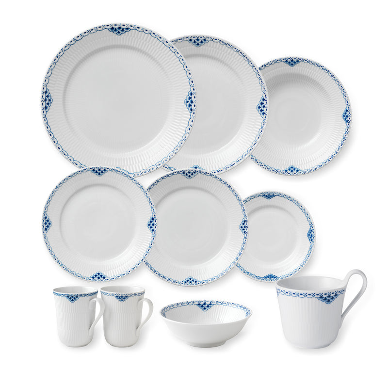 White porcelain dinnerware set with blue trim: plates, bowls, and mugs