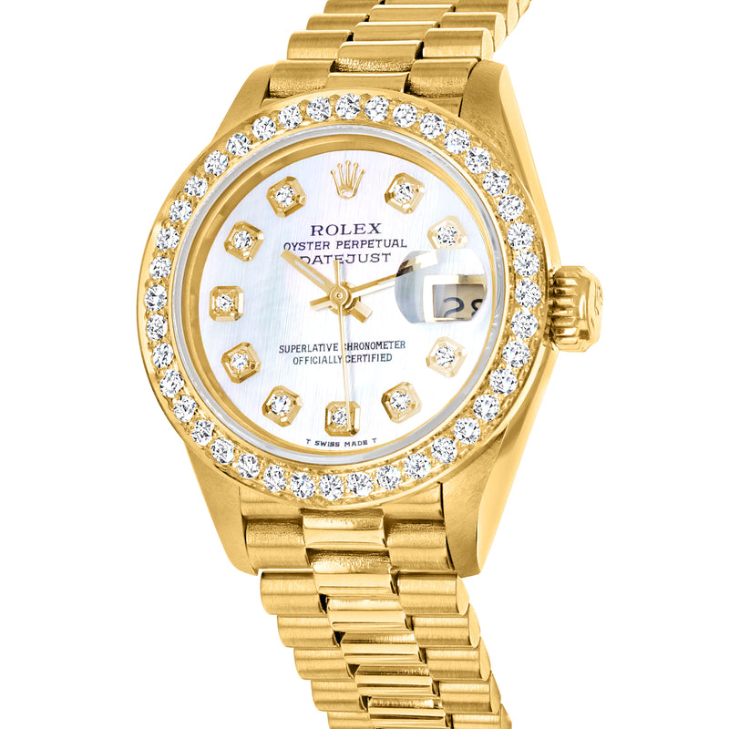Yellow gold Rolex Datejust close-up with diamond bezel, gold dial markers, and crown