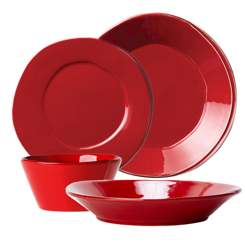 Glossy red ceramic dinnerware set with plates and bowls, round shapes