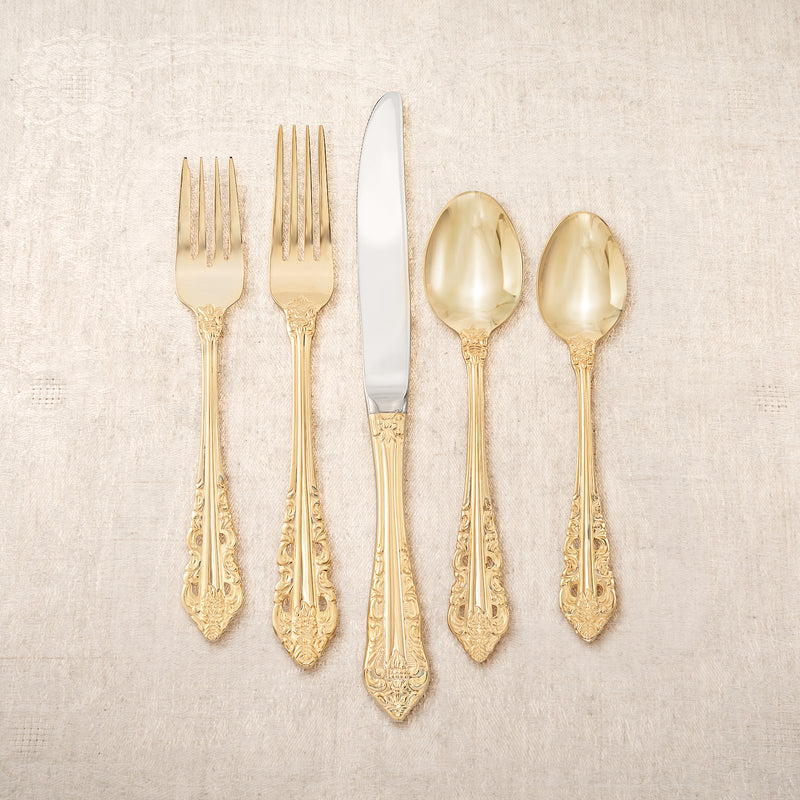 Gold-plated baroque flatware set with forks, knife, and spoons, ornate handles