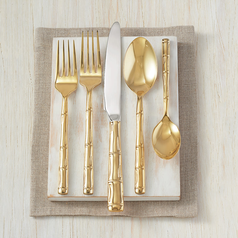 Gold-plated stainless steel flatware set with bamboo-style handles: spoons and forks.