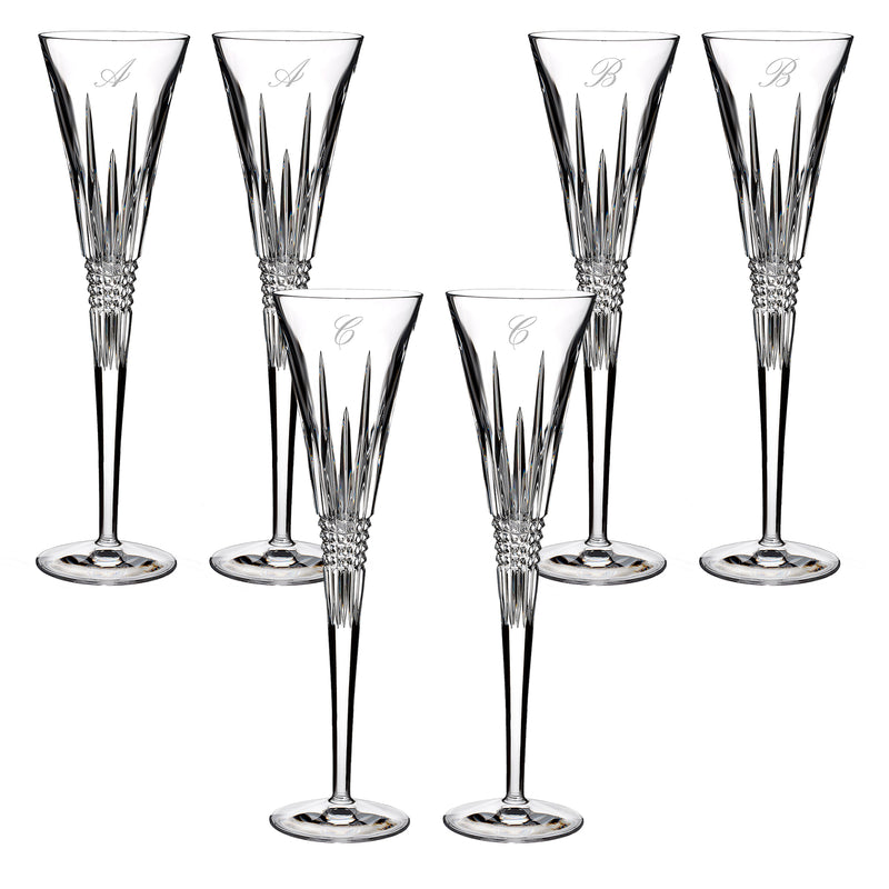 Clear crystal toasting flutes with diamond-cut stems and engraved script initials A and B