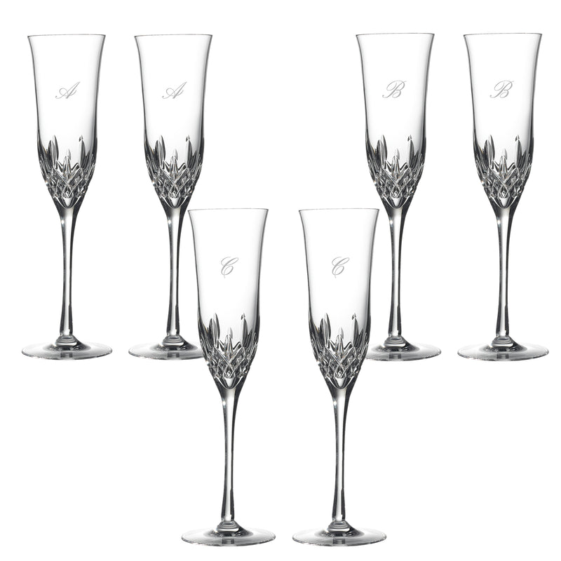 Set of two clear crystal toasting flutes with faceted base and script initials