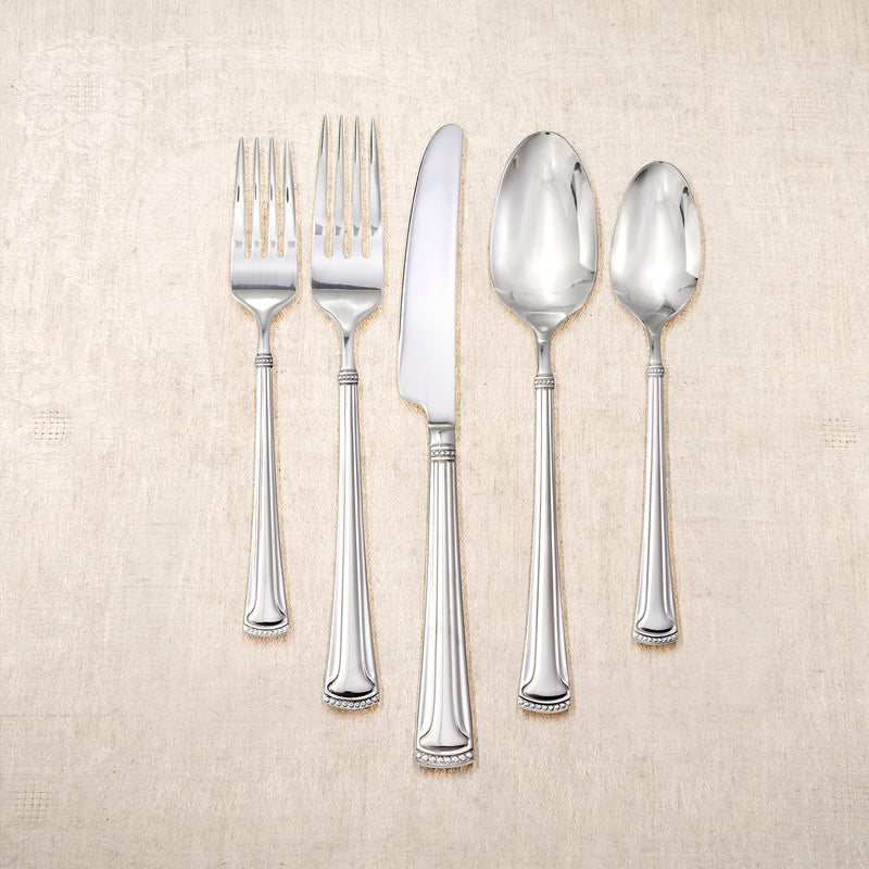 Stainless steel flatware set for 4 with forks, knives, and serving spoons
