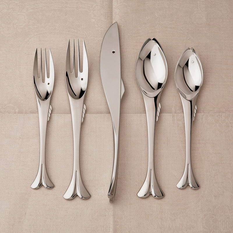 Stainless steel flatware set with two forks, two spoons, and serving knife