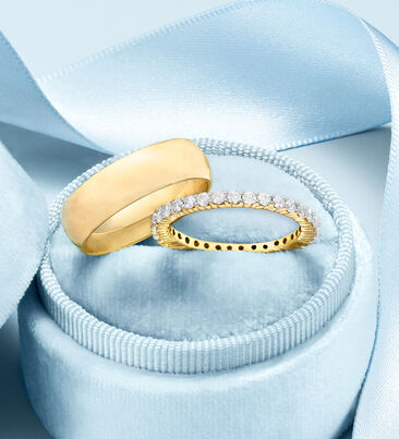 With this ring. Make it official with bands of love. Image of two wedding bands.