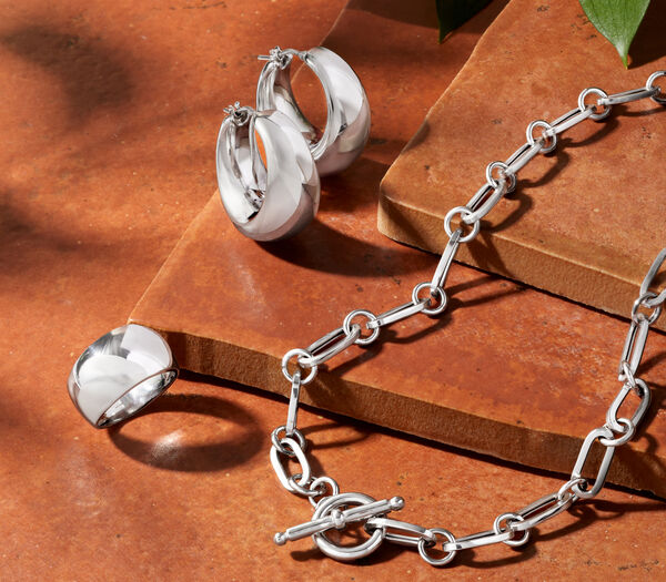 Alluring Sterling -- High-shine silver direct from Italy. Image Featuring Sterling Silver Bracelets On White Marble.