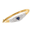 C. 1980 Vintage 1.25 Carat Sapphire and .75 ct. t.w. Diamond Heart Bangle Bracelet in 14kt Yellow Gold