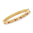 C. 1990 Vintage .90 ct. t.w. Ruby and .20 ct. t.w. Diamond Heart Bangle Bracelet in 18kt Yellow Gold