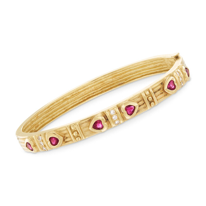 C. 1990 Vintage .90 ct. t.w. Ruby and .20 ct. t.w. Diamond Heart Bangle Bracelet in 18kt Yellow Gold