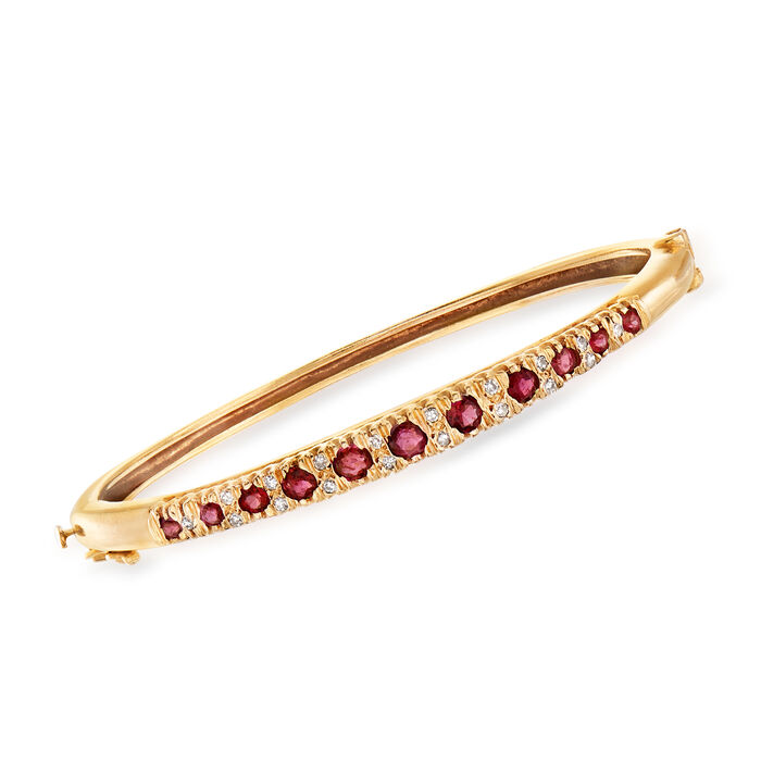 C. 1980 Vintage 1.35 ct. t.w. Ruby and .30 ct. t.w. Diamond Bangle Bracelet in 14kt Yellow Gold