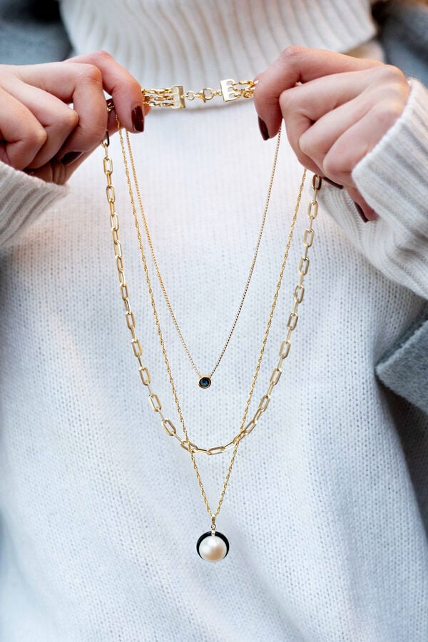 girl holding 3 necklaces