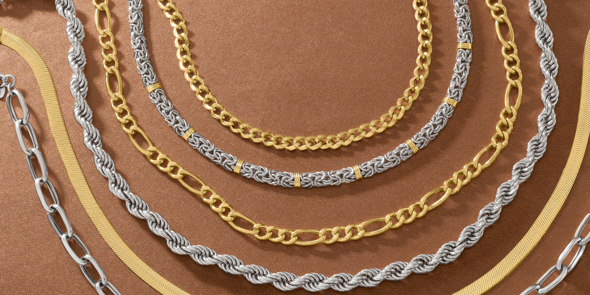 mutiple styles of necklaces like herringbone, silver and gold byzantine, cuban