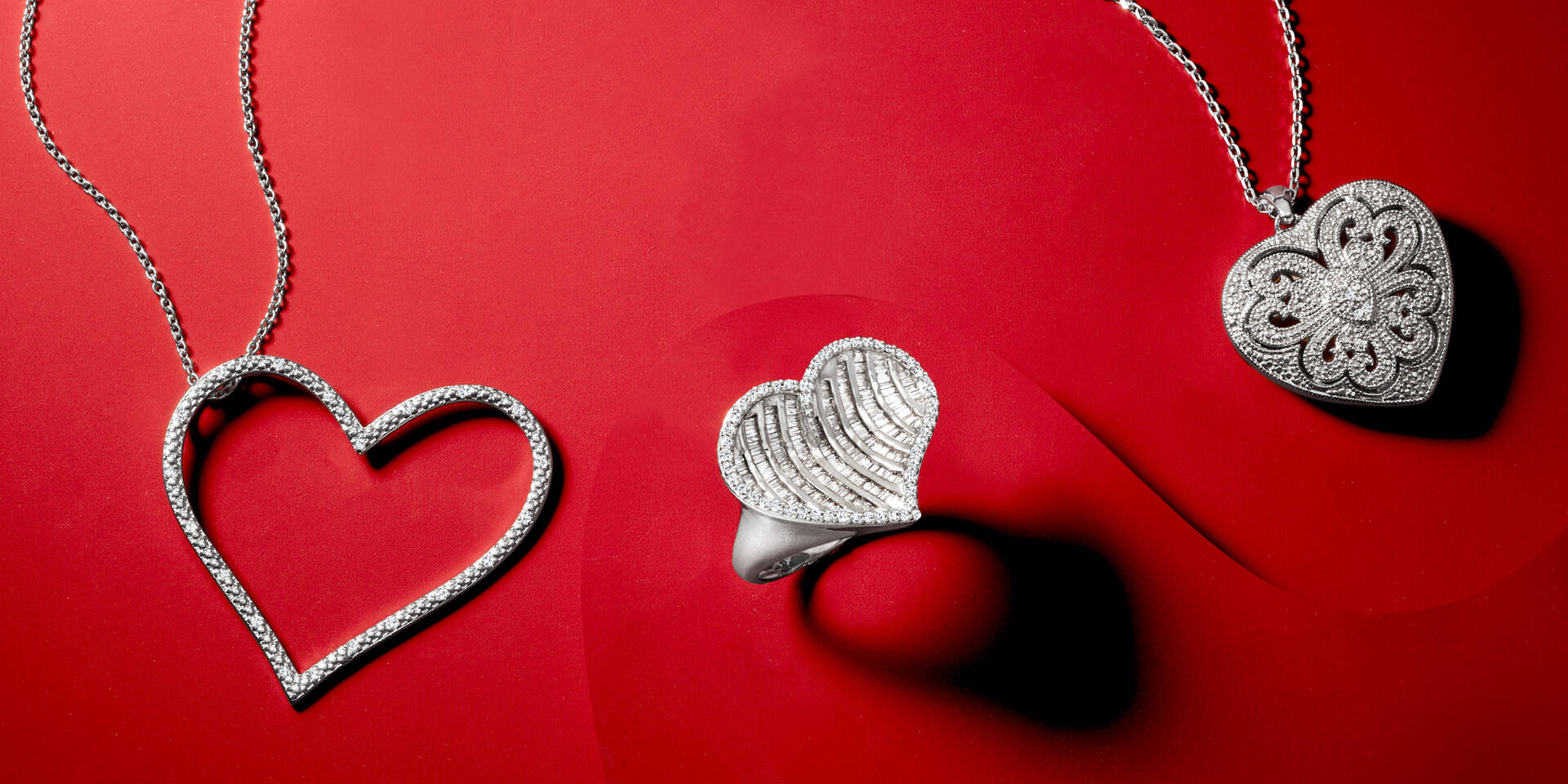 2  heart shaped necklaces and a heart shaped ring