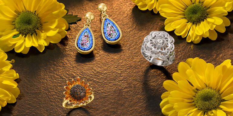 Woman Holding a Gift and Wearing Many Different Rings