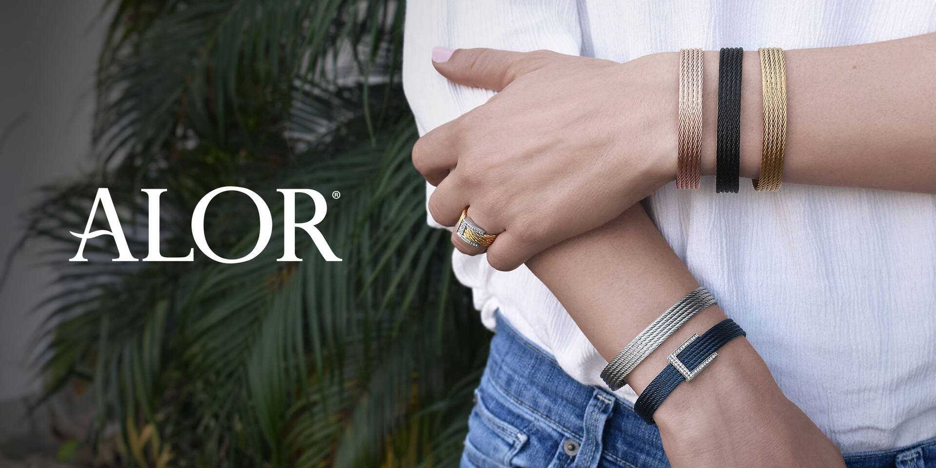 model wearing bracelet and ring in woven metal with alor text on left
