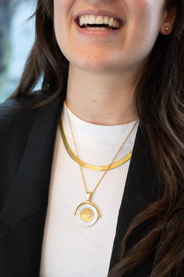 girl wearing two necklace