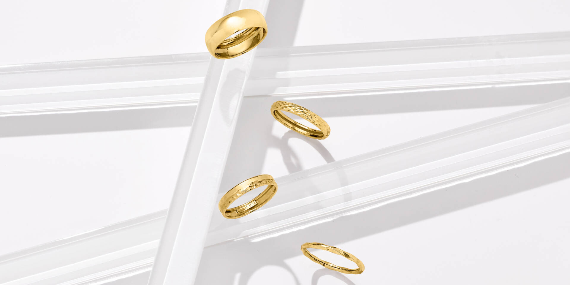 4 gold band rings appearing to fall