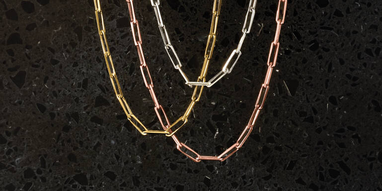 Woman Holding a Gift and Wearing Many Different Rings