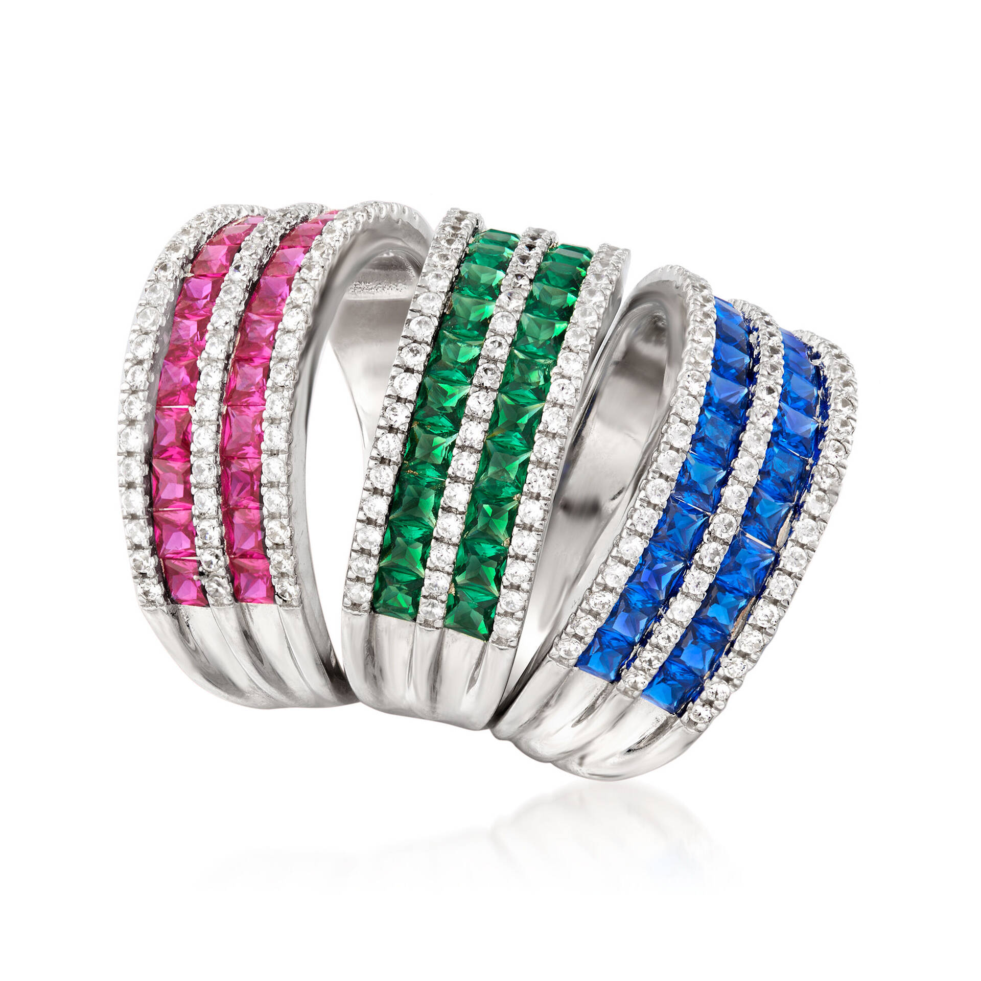 three gemstone rings in red green and blue